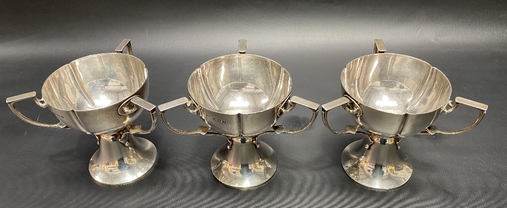 A good set of three Edwardian Art Nouveau three handled pedestal cups by William Aitken, the lobed - Image 2 of 2