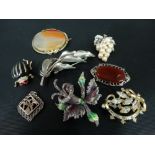 A collection of brooches, some silver