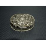 Edwardian silver oval hinge lidded trinket box with foliate and C scroll decorations, maker C & S,