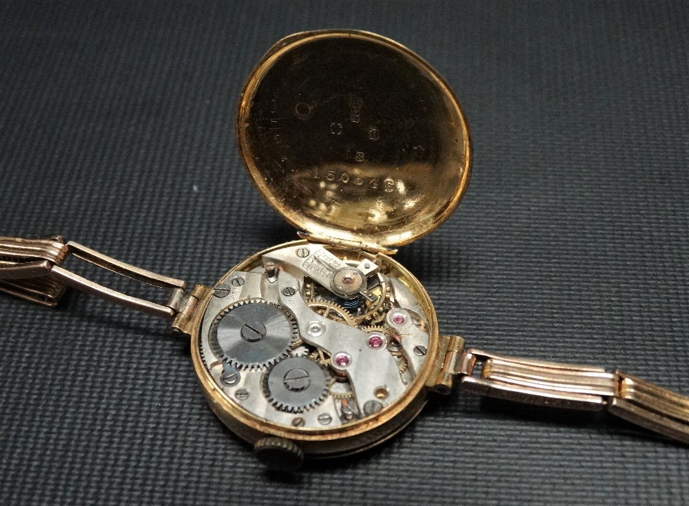 A 1920's 18ct gold cased half hunter ladies manual wind wristwatch, the 21mm white enamel dial - Image 2 of 2