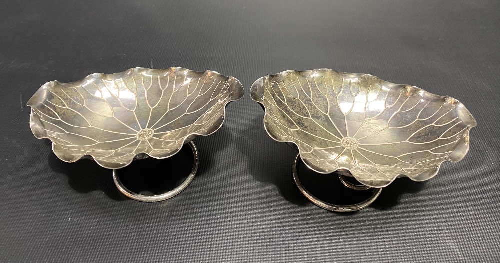 Pair of Chinese white metal lotus leaf shaped oval lobed bonbon dishes by Wang Hing upon wire