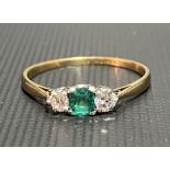 18ct gold diamond and emerald three stone ring, the diamonds measuring 0.07ct spread approx,