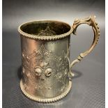 Victorian silver mug with foliate embossed and strapwork design and with beaded rim and base,