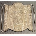 A Chinese export silver large buckle by Tien Shing, embossed with a fo dog to the centre with a