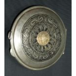 An Egyptian white metal filigree and niello compact, the hinged lid filigree decorated and with a