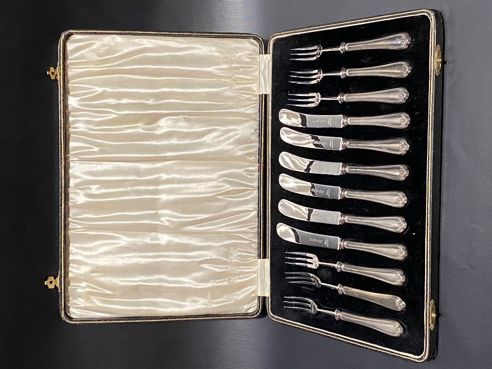 Cased silver fruit knife and fork set with weighted handles, maker H.F & Co, Sheffield 1931.