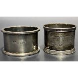 Victorian silver napkin ring with Greek key engraved decoration, London 1864; together with a George