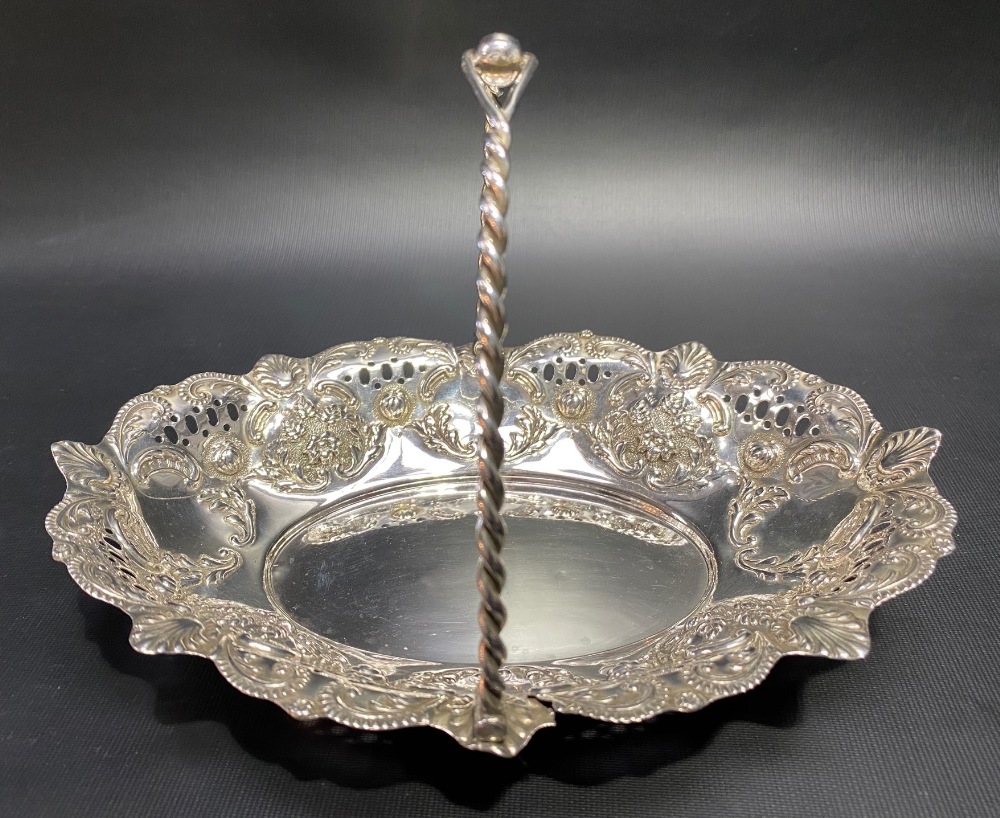 Victorian silver swing handled basket with foliate scroll embossed and pierced decoration and with