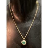 An attractive modern 9ct gold emerald and diamond pendant necklace, the emerald of heart shape