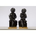 A pair of bronze puttis on a marble base, 19th century (40cm)