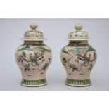 A pair of Nankin lidded vases 'warriors' (*) (37cm)