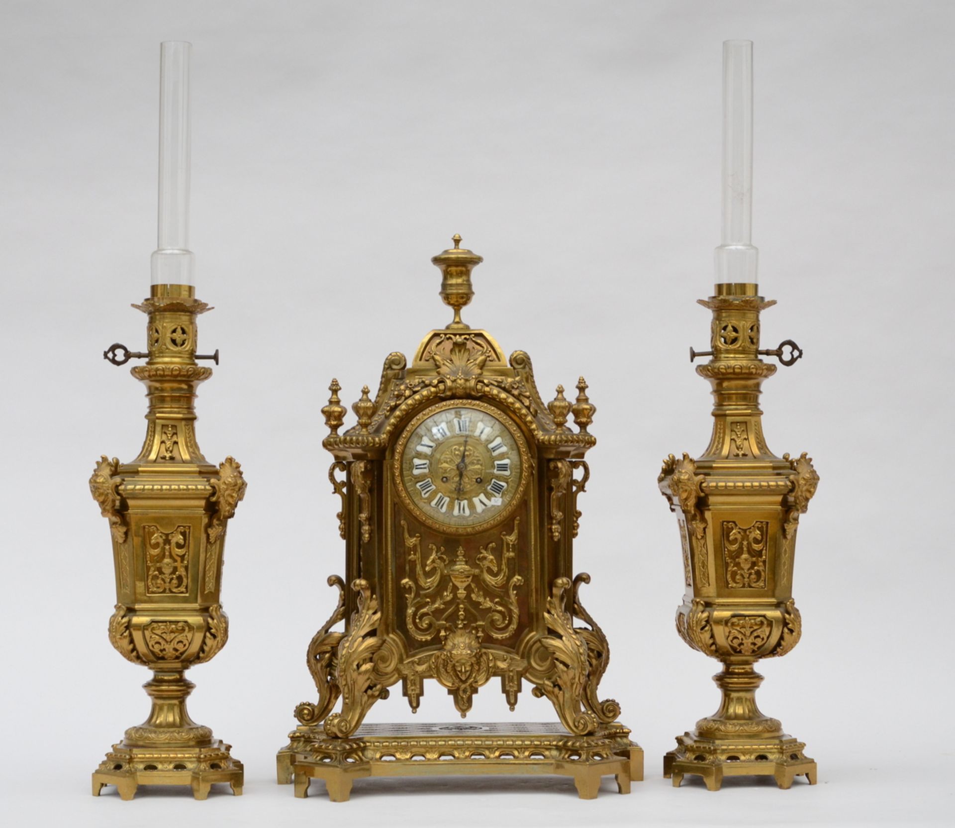 A bronze clock set in Henri II style
