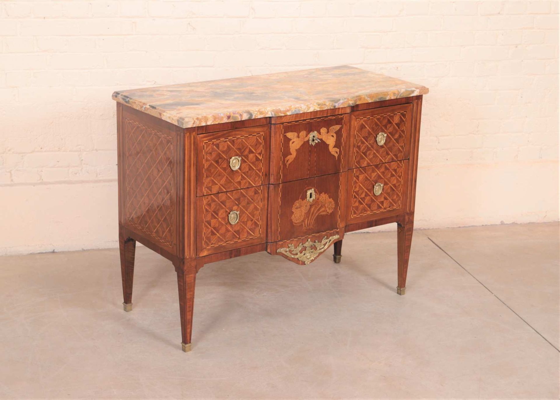 Commode Louis XVI en marqueterieEn marqueterie de bois de rose et amarante. Commode sauteuse à