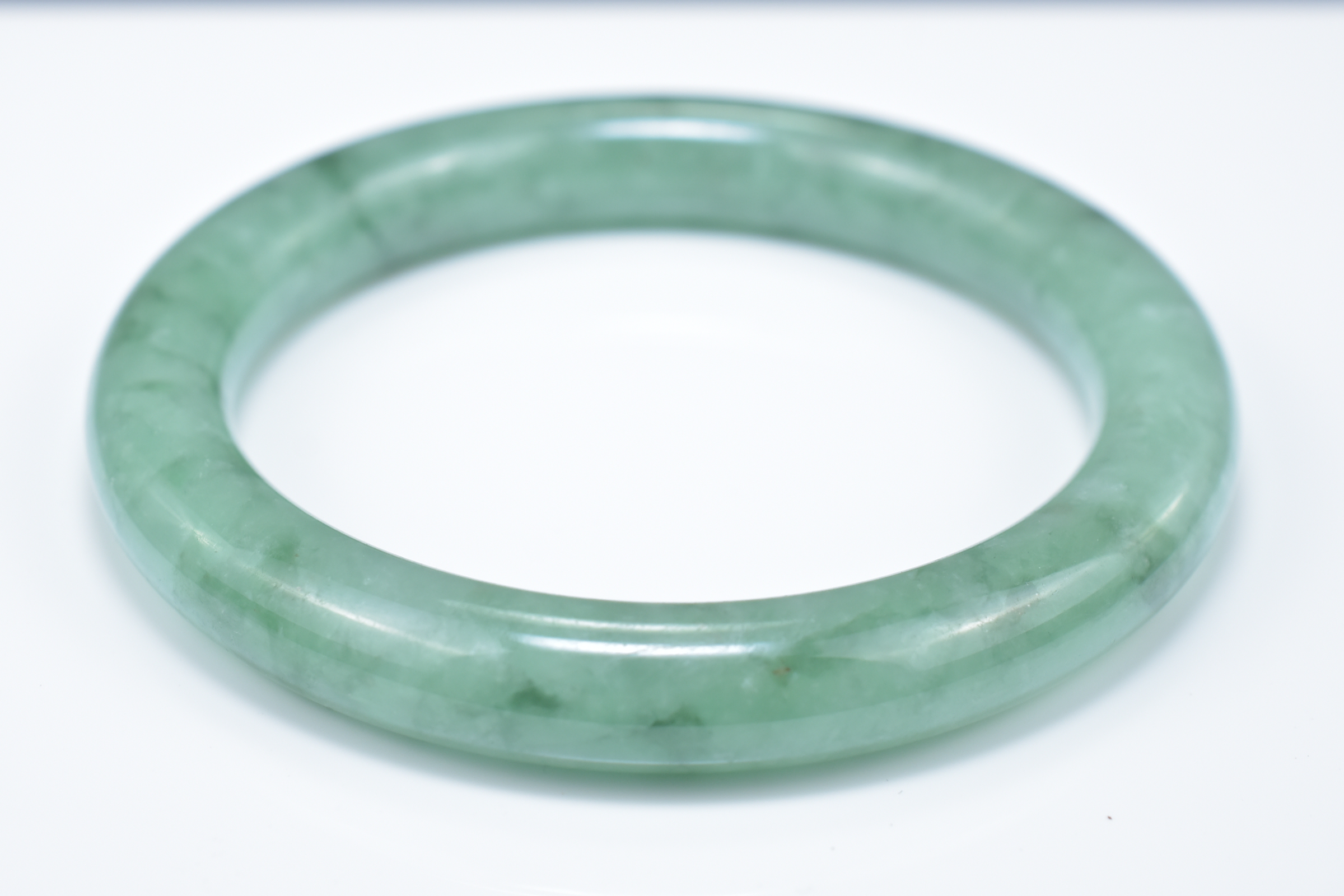 A Chinese pale and green jadeite bangle. 6cm inner diameter - Image 4 of 4