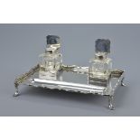 An English Sterling silver inkstand on four legs and with two glass pots with silver covers. Hallmar