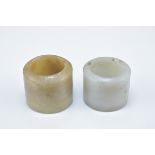 Two Chinese carved jade archers rings. 2.5cm and 3cm length (2)
