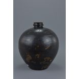A Chinese black glazed Jin / Song dynasty globular jar with shallow neck decorated with painted leav