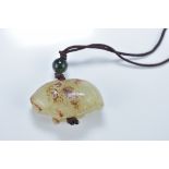 A Chinese carved celadon and brown jade animal pendant. 4.5cm length