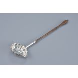 A Georgian George III Silver ladle with turned wood handle. London 1767. Maker D M. Length 33cm.