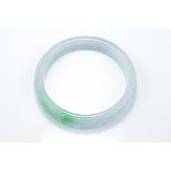 A Chinese carved jadeite bangle in pale white and green tone. Carved with Lingzhi. 5.75cm inner diam