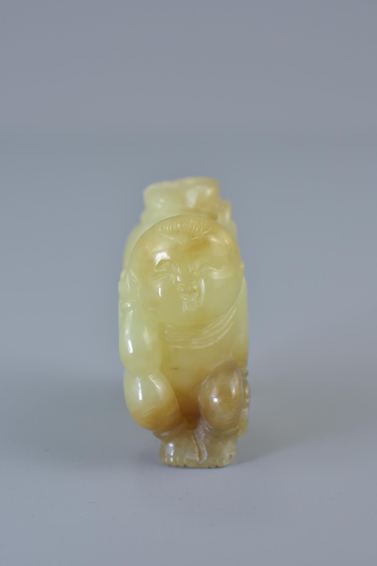 A Chinese celadon and brown jade carving of two boys. 5cm x 5cm - Image 3 of 5