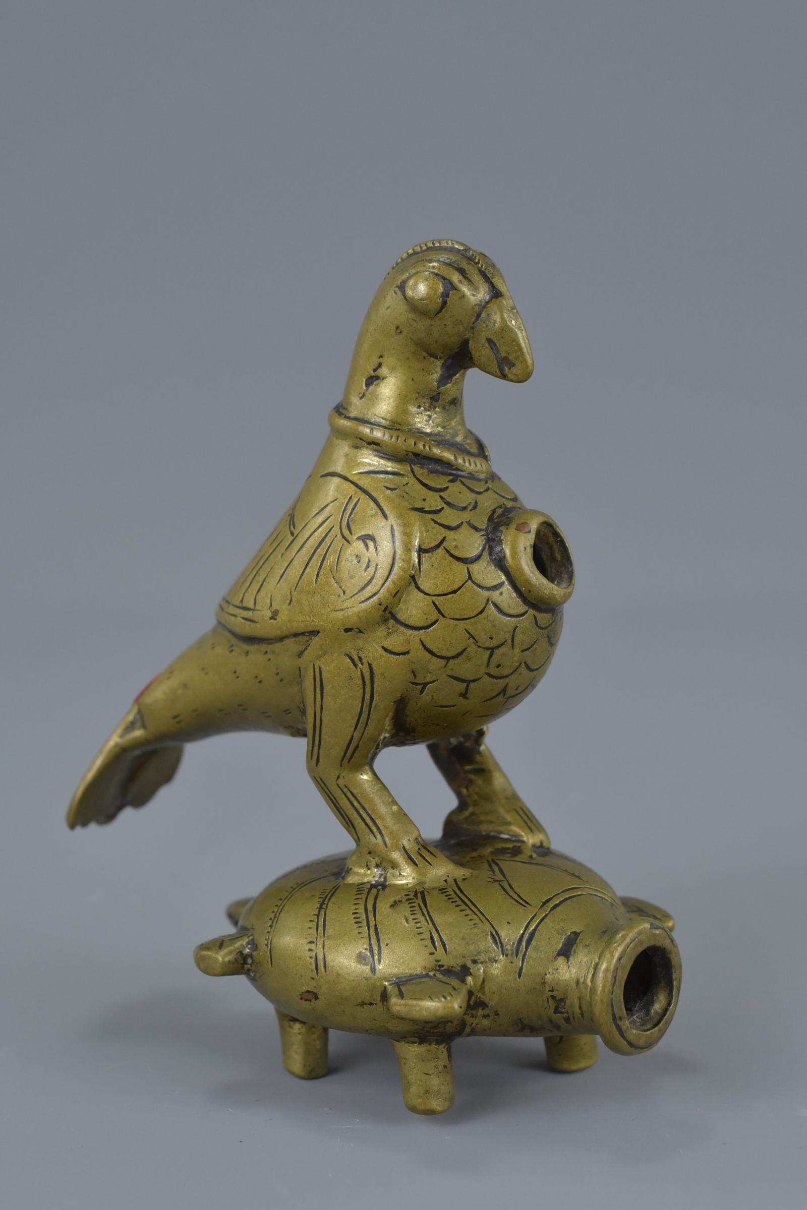 A Middle Eastern bronze fitting in the form of a bird and turtle on for legs. 11cm tall