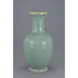 A Chinese 19th century celadon porcelain vase with brownish rim. (Hole to base) 36cm tall