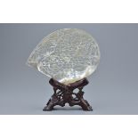 A Chinese vintage mother-of-pearl shell with pierced decoration depicting birds in tree on wooden st