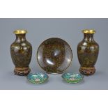A pair of Chinese cloisonné vases on wooden stands with floral decoration together with a matching s