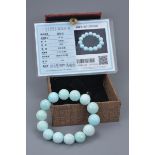 A Chinese turquoise beaded bracelet with 14 spherical beads. 62.69 grams total. 15mm diameter each b
