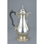 An English sterling silver coffee pot with wooden handle. Hallmarked and dated 1934 London, Maker Ja