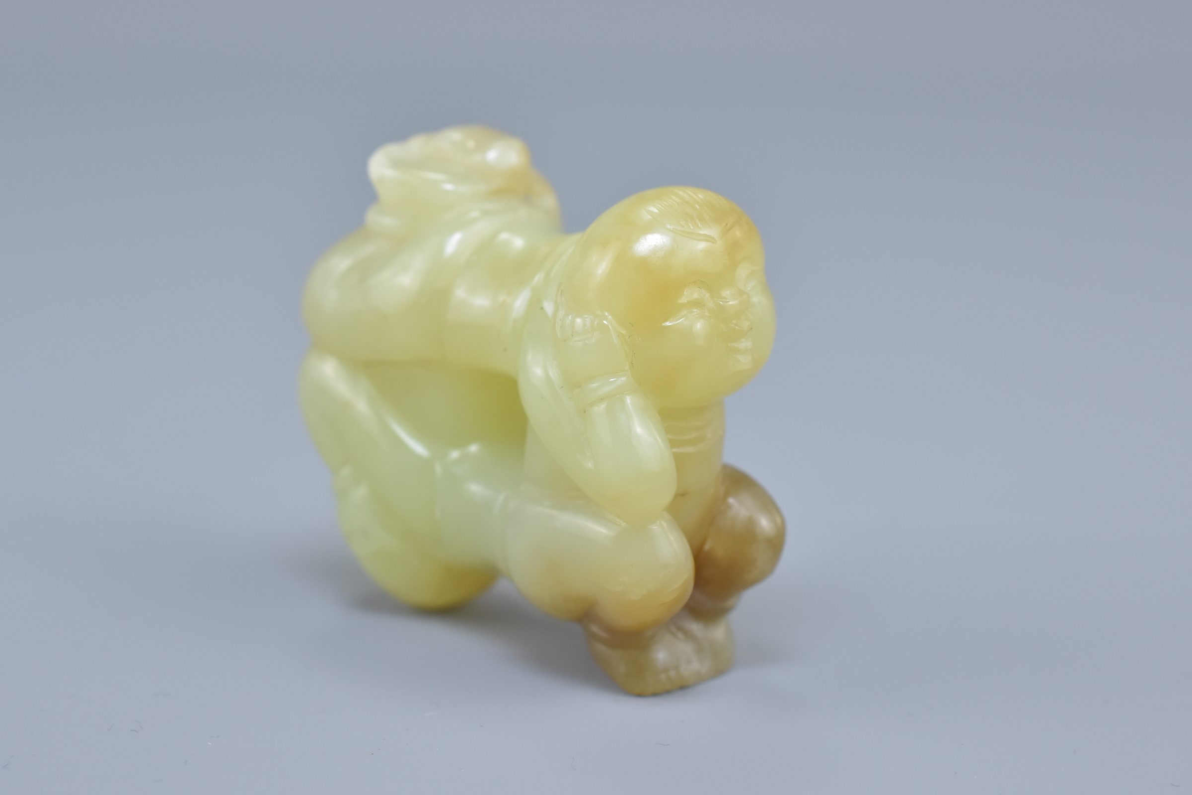 A Chinese celadon and brown jade carving of two boys. 5cm x 5cm - Image 5 of 5