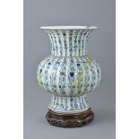 A Chinese doucai porcelain vase with fluted neck bearing six character mark of Qianlong to base on w