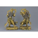 A pair of Chinese gilt bronze figures of Guardians standing on Mythical beasts. 37cm tall 4882 grams