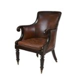 A William IV library chair with brown studded leather on four brass wheels. 56cm width