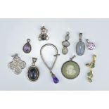 A group of nine various pendants to include a Wedgwood Silver mounted Cameo pendant, a silver bear p