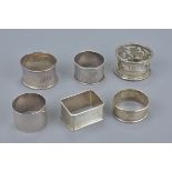 A group of six various English sterling silver napkin rings. All hallmarked. Total weight 124 grams