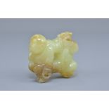 A Chinese celadon and brown jade carving of two boys. 5cm x 5cm
