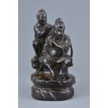 A Chinese 19th century hardwood carving of figure having his ear cleaned. 18.5cm tall