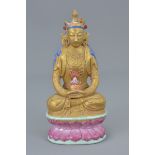 Chinese Porcelain 18th or 19th century Famille Rose Seated figure of Guanyin on lotus stand, 13cms h
