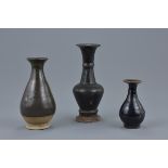 Three Chinese Song / Ming dynasty black glazed pottery vases. 9cm - 16.5cm