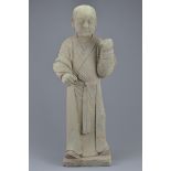 A Chinese Ming dynasty or later carved standing stone figure of a young attendant. 74cm tall