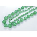 A string of Chinese graduated jadeite beads. 92cm length. Beads 5mm-10mm