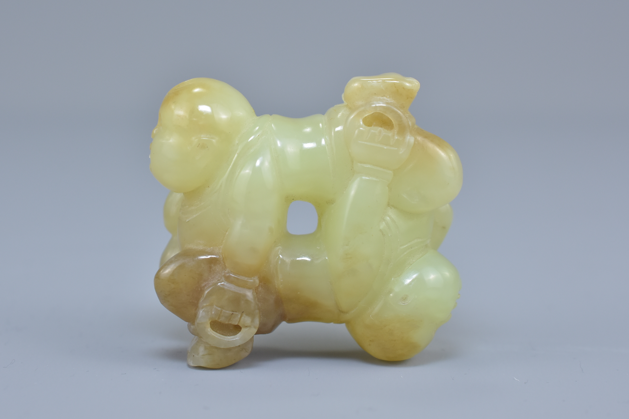 A Chinese celadon and brown jade carving of two boys. 5cm x 5cm - Image 2 of 5