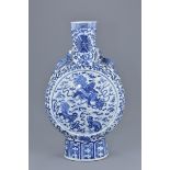 A large Chinese 19th century blue and white porcelain moon flask decorated with foo dogs to each sid