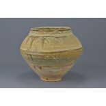 A Chinese 12/13th century pottery jar with unusual glazing. Decorated with floral motifs and a brown