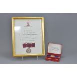 A framed and glazed medal in commemoration of Her Majesty's Coronation 2nd June, 1953. Together with