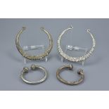 Two Eastern white metal torque / torc necklace together with two smaller white metal bangles. Neckla