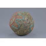 A large Tibetan decorative ball with hammered white metal design with turquoise and faux coral stone