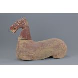 A Chinese Han Dynasty (206BC - 220AD) painted pottery seated horse with separate head. 40cm length
